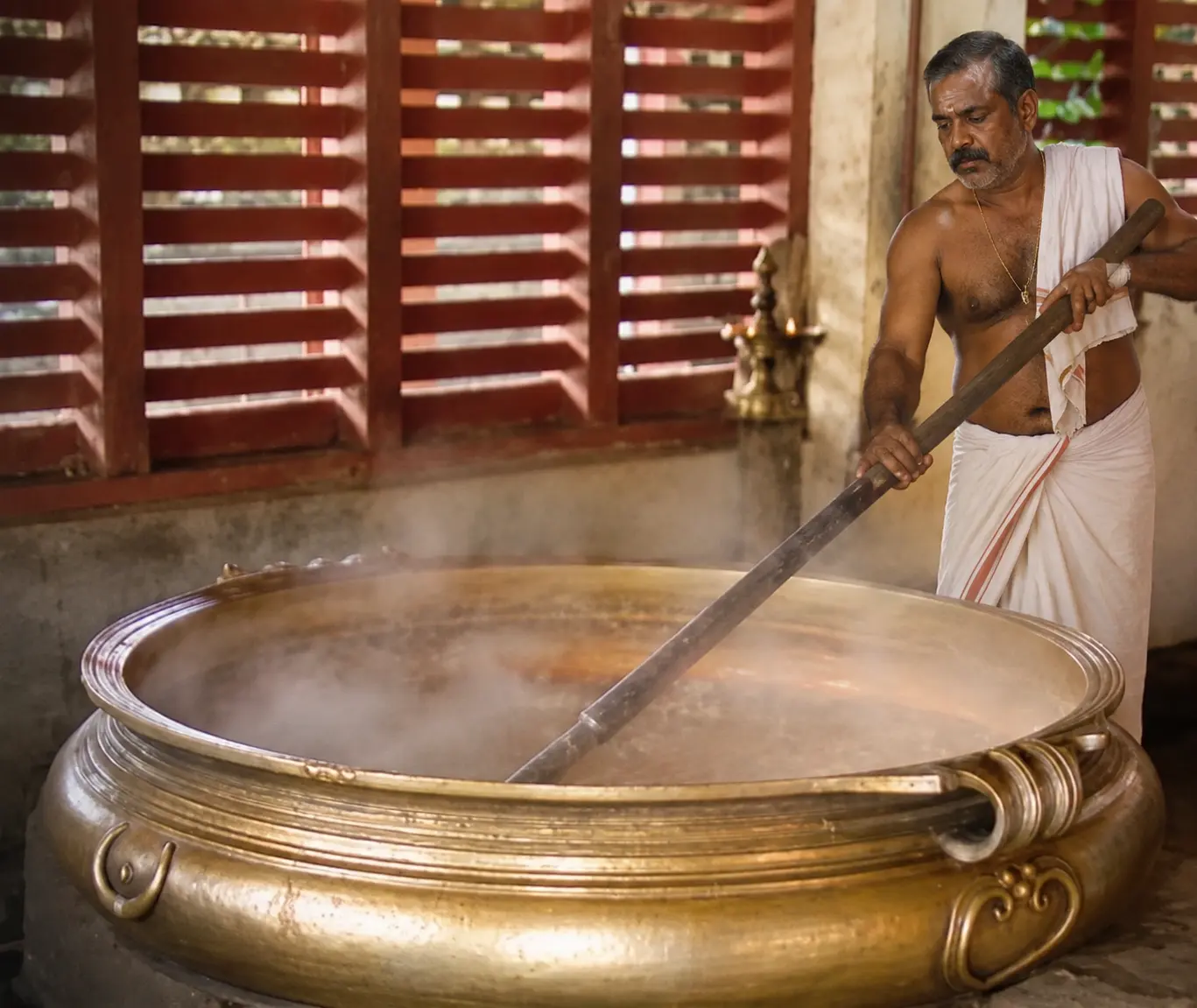 Palpayasam being stirred in the temple's giant urn at Ambalappuzha